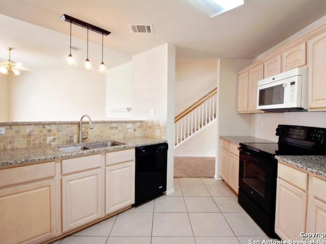 kitchen featuring ceiling fan, sink, black appliances, light tile patterned floors, and decorative light fixtures