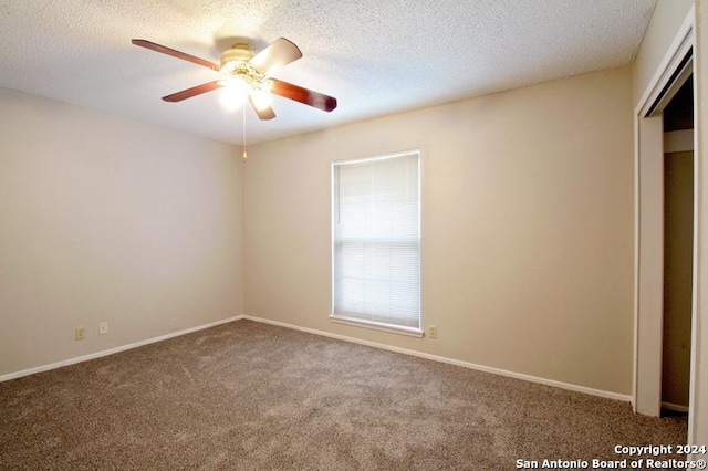 unfurnished bedroom featuring ceiling fan, carpet, and a textured ceiling