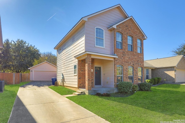 view of front of house with central AC, an outbuilding, a front yard, and a garage