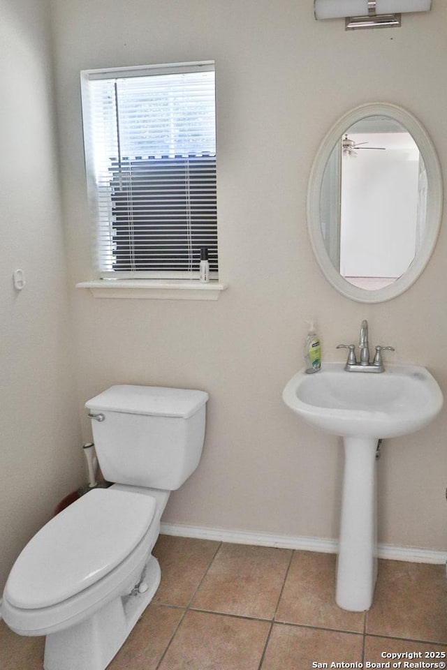 bathroom with tile patterned flooring, toilet, and sink