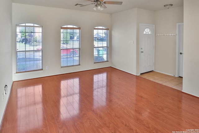 unfurnished room featuring ceiling fan and light wood-type flooring