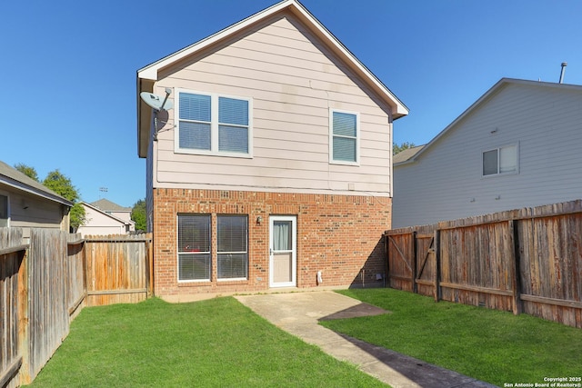 back of house featuring a lawn