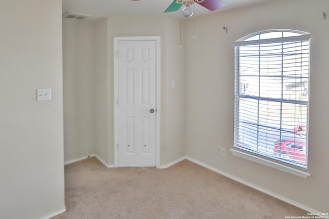 unfurnished room with light carpet and ceiling fan