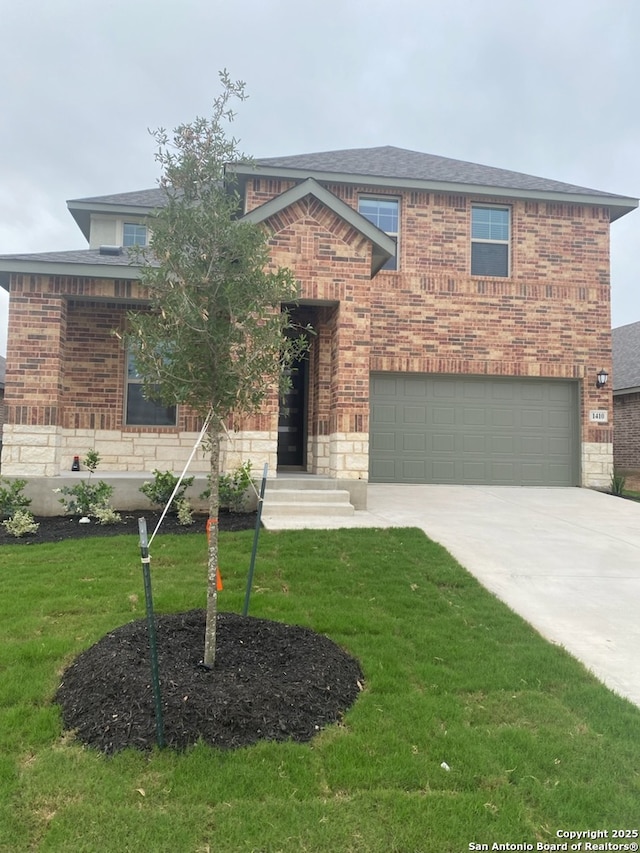 view of front of house featuring a garage and a front yard