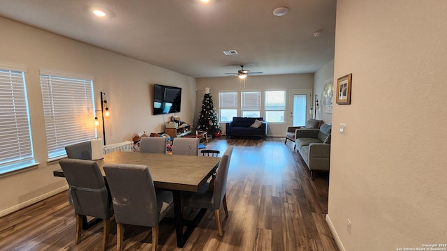 dining area featuring ceiling fan and dark wood-type flooring