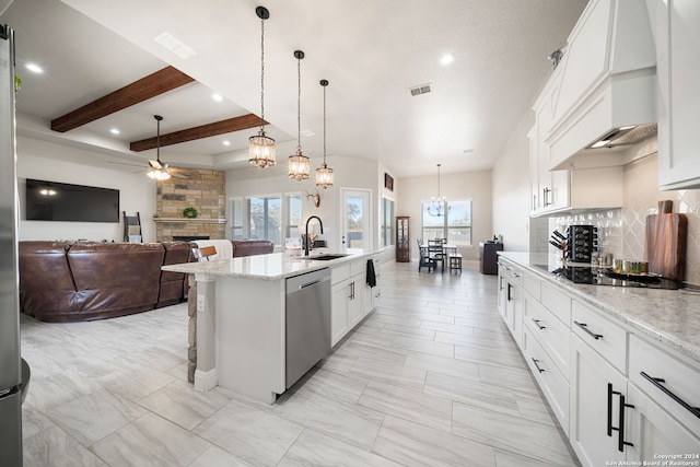 kitchen with white cabinetry, sink, stainless steel dishwasher, decorative light fixtures, and black electric cooktop