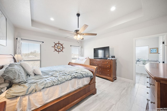 bedroom with a tray ceiling, multiple windows, and ceiling fan