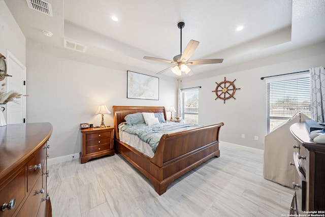 bedroom featuring a tray ceiling and ceiling fan