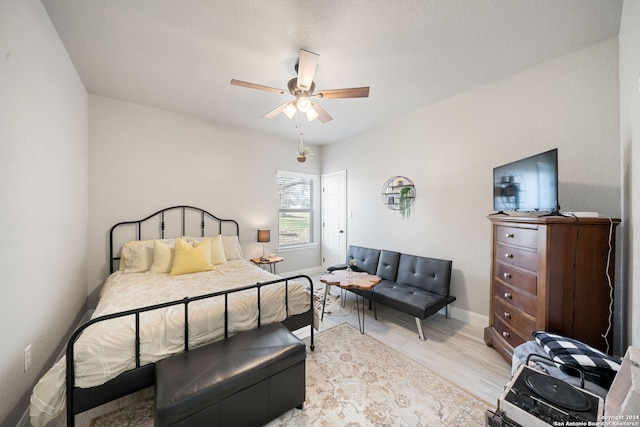 bedroom with ceiling fan and light hardwood / wood-style floors