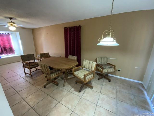 tiled dining area with ceiling fan