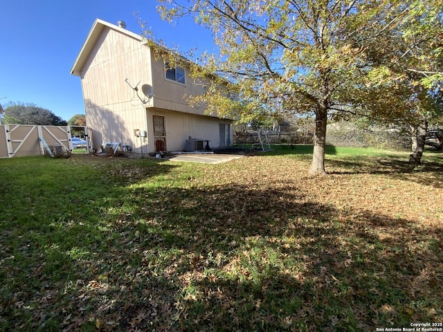 rear view of house featuring a patio, central AC unit, and a lawn