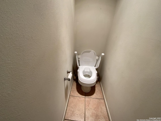 bathroom with tile patterned flooring and toilet