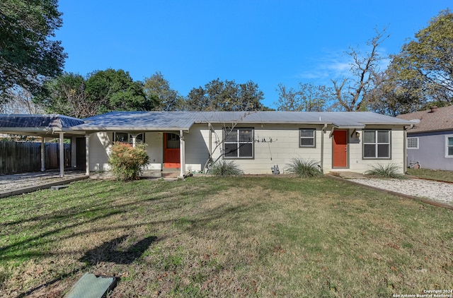 ranch-style house featuring a front yard and a carport