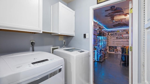 laundry room with separate washer and dryer, a fireplace, and cabinets