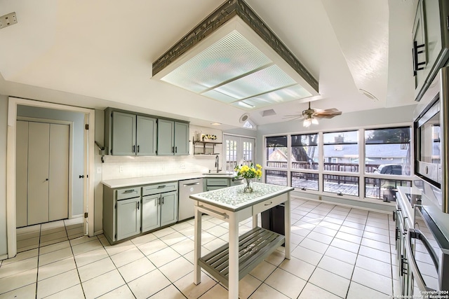 kitchen featuring ceiling fan, french doors, stainless steel dishwasher, light tile patterned flooring, and green cabinetry