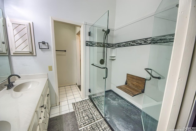 bathroom with tile patterned flooring, vanity, and a shower with shower door