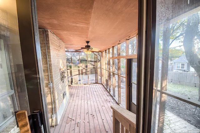 unfurnished sunroom with ceiling fan and wooden ceiling