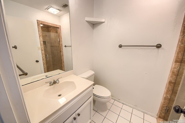 bathroom with tile patterned flooring, vanity, toilet, and a shower with door