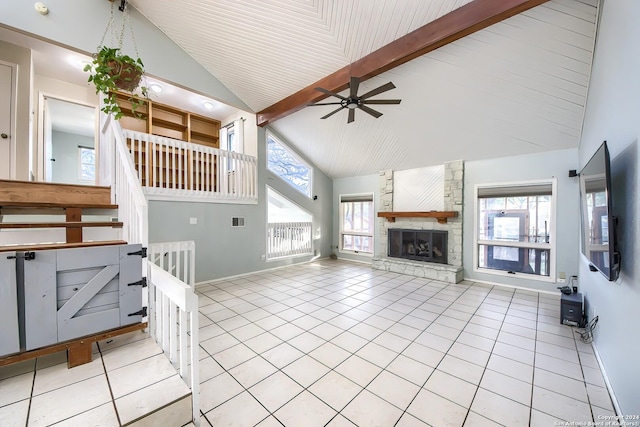 tiled living room featuring beamed ceiling, high vaulted ceiling, a fireplace, and ceiling fan