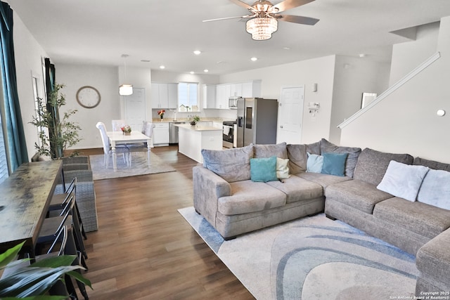 living room featuring ceiling fan and dark hardwood / wood-style flooring