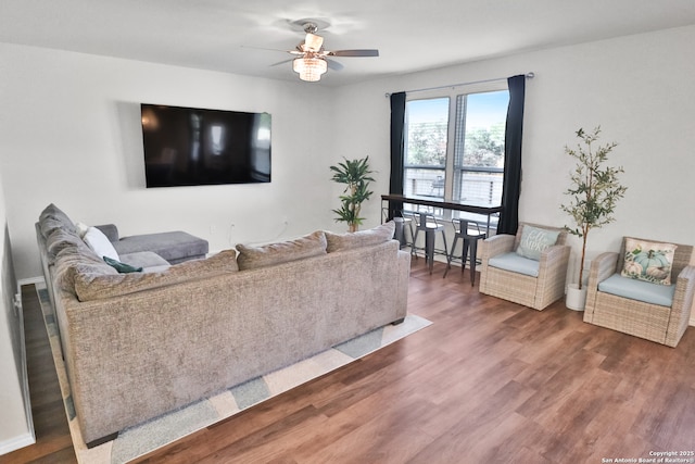 living room featuring dark hardwood / wood-style floors and ceiling fan