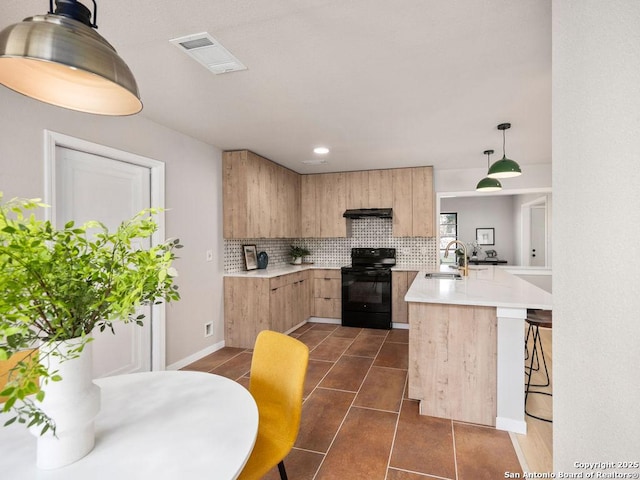 kitchen with pendant lighting, black / electric stove, sink, light brown cabinetry, and tasteful backsplash