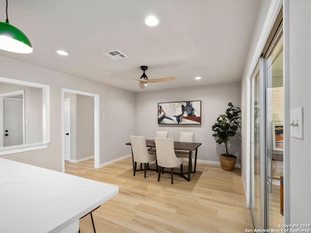 dining room with ceiling fan and light hardwood / wood-style flooring