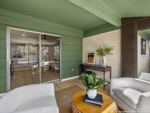 living room featuring hardwood / wood-style floors and beam ceiling