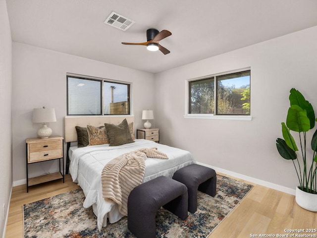 bedroom with ceiling fan and wood-type flooring