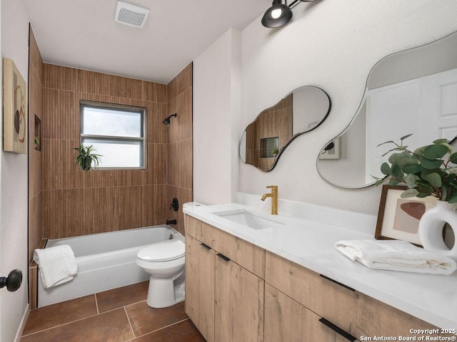 full bathroom featuring vanity, tile patterned floors, tiled shower / bath combo, and toilet