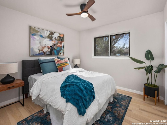 bedroom with ceiling fan and light hardwood / wood-style floors