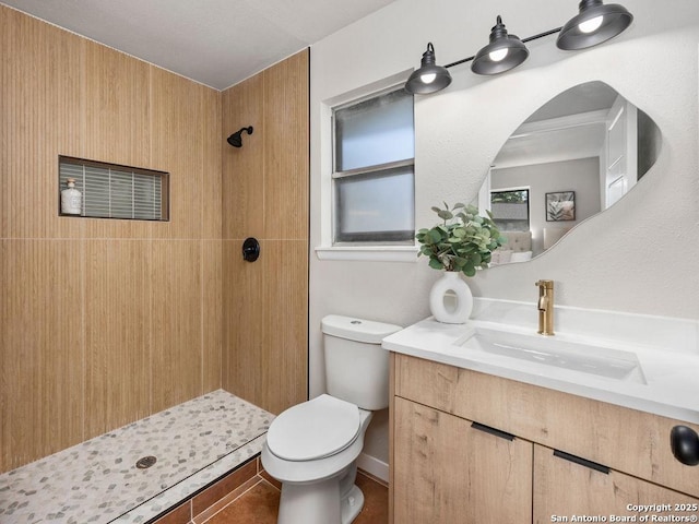 bathroom with a shower, vanity, and toilet