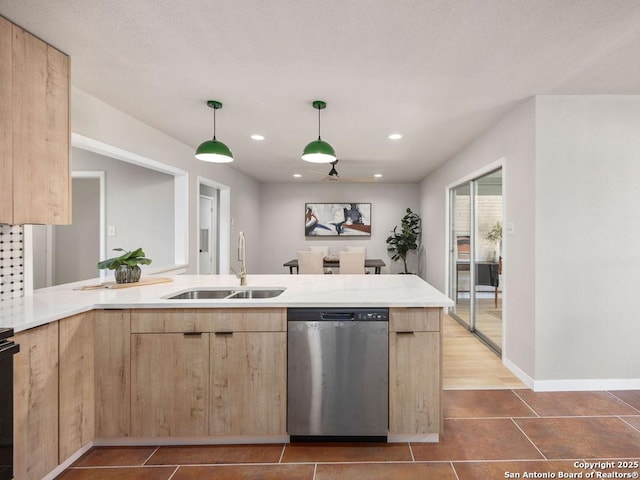 kitchen featuring pendant lighting, dishwasher, light brown cabinets, sink, and kitchen peninsula