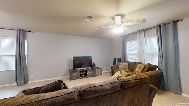 living room with ceiling fan, plenty of natural light, and light carpet