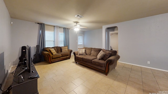 tiled living room featuring ceiling fan