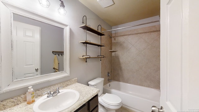 full bathroom with vanity, toilet, and tiled shower / bath