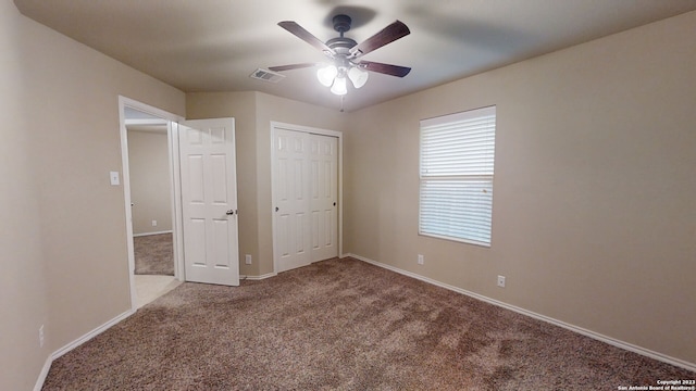 unfurnished bedroom with carpet flooring, ceiling fan, and a closet