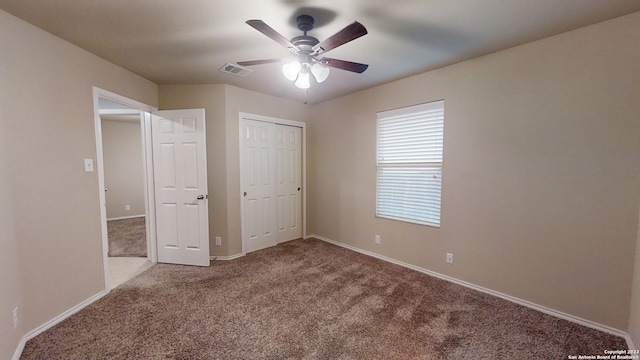 unfurnished bedroom featuring carpet, ceiling fan, and a closet