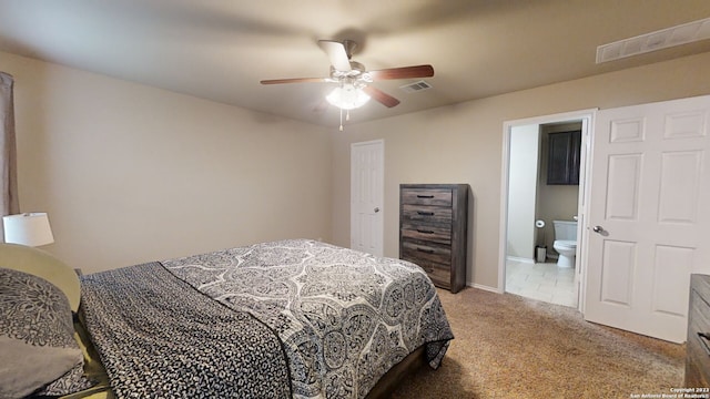 bedroom with carpet flooring, ensuite bath, and ceiling fan