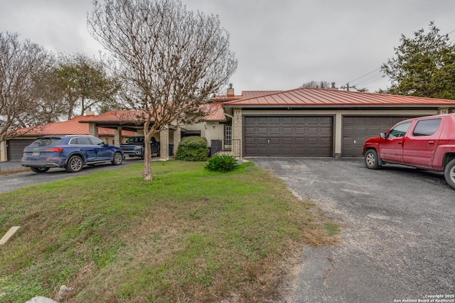 single story home featuring a front yard and a garage