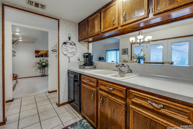 kitchen with dishwasher, sink, a chandelier, decorative light fixtures, and light carpet