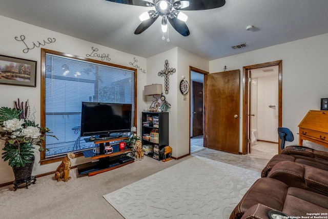 living room with ceiling fan and light colored carpet