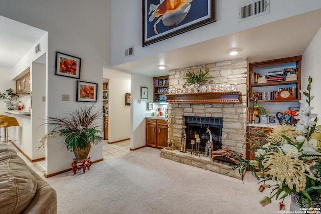 carpeted living room with a fireplace