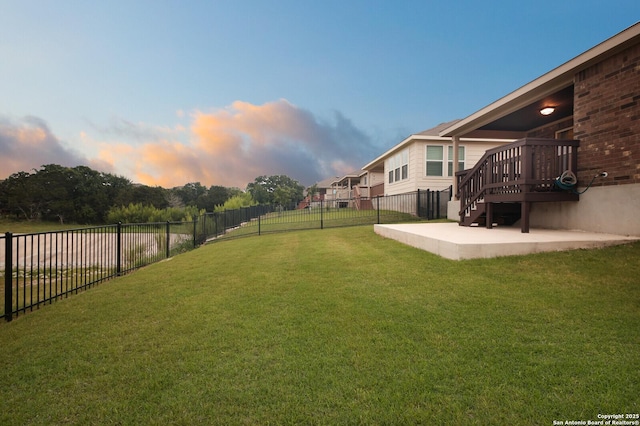 yard at dusk with a patio area