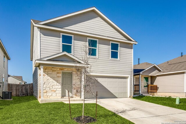 view of front of house with central AC unit, a front yard, and a garage