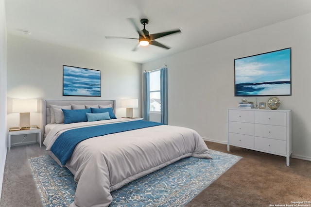 bedroom with ceiling fan and dark carpet