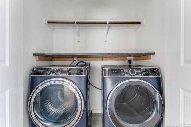 clothes washing area featuring washer and dryer