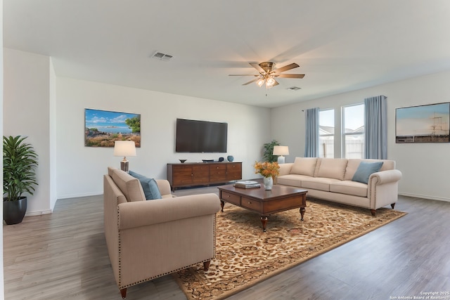 living room featuring ceiling fan and wood-type flooring