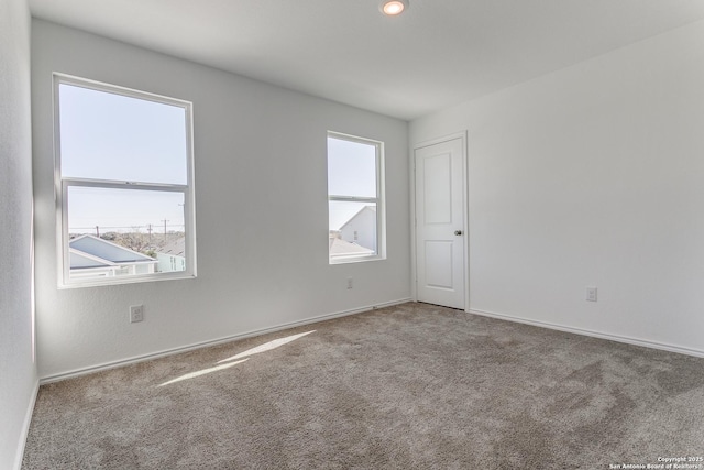 carpeted spare room with a wealth of natural light