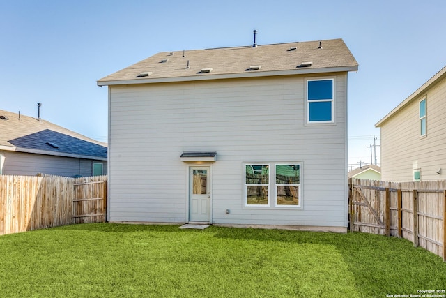 rear view of house featuring a yard